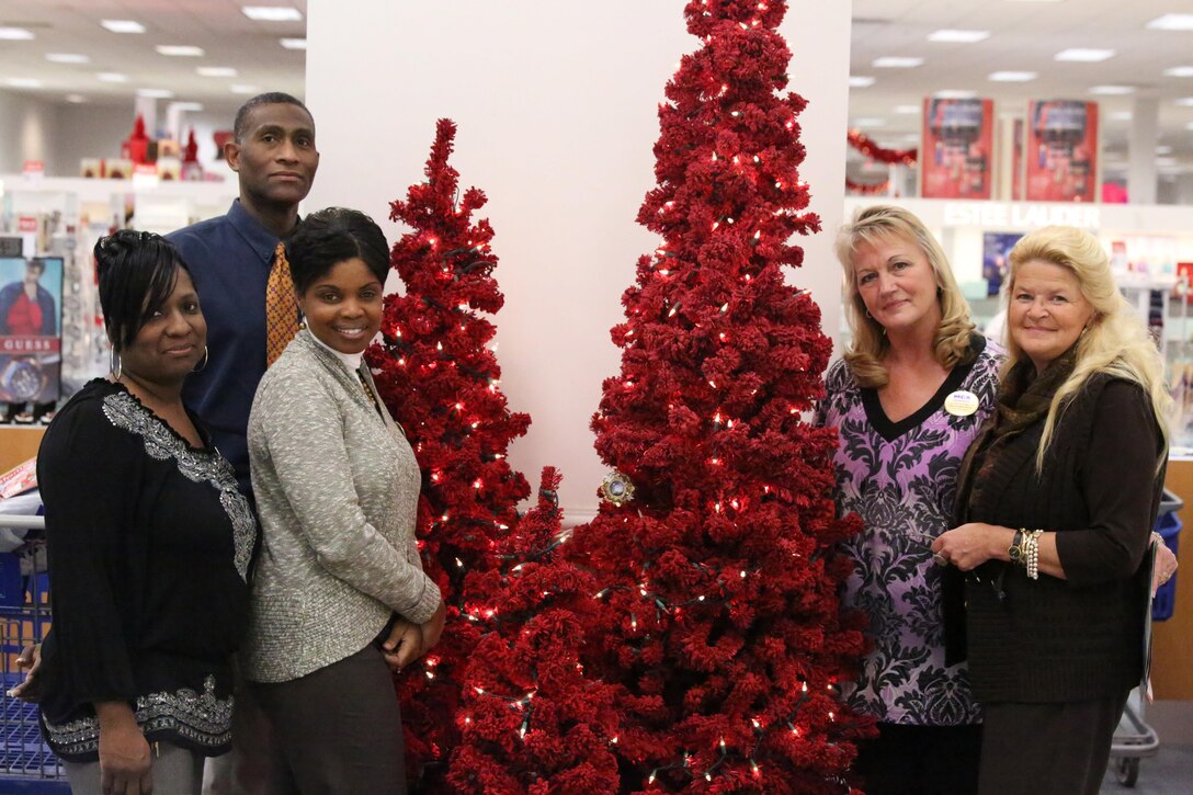 Tasha Spencer, Marine Corps Community Services retail director, poses with some of her employees at the Marine Corps Exchange on Dec. 4, 2013. Spencer has worked in retail for 11 years. 