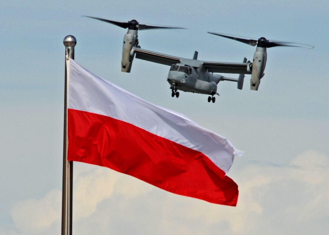 An MV-22B Osprey hovers in front of flags from participating nations during an aerial demonstration at the 4th biennial Brunei Darussalam International Defense Exhibition at the BRIDEX Exhibition Center in Bandar Seri Begawan, Brunei, Dec. 5, 2013. The five-day event includes displays and demonstrations of military equipment, with the theme of bridging the capability gap. BRIDEX 13 is an opportunity for communication and cooperation with regional partners and allies, builds strong multilateral relationships and enhances preparedness for disasters and other contingency operations. U.S. participation in BRIDEX 13 demonstrates cooperative engagement with Brunei and continued commitment to regional security and stability in the Asia-Pacific region. The Osprey is with Marine Medium Tiltrotor Squadron 262, Marine Aircraft Group 36, 1st Marine Air Wing, III Marine Expeditionary Force. (U.S. Air Force photo/Master Sgt. Jerome S. Tayborn)