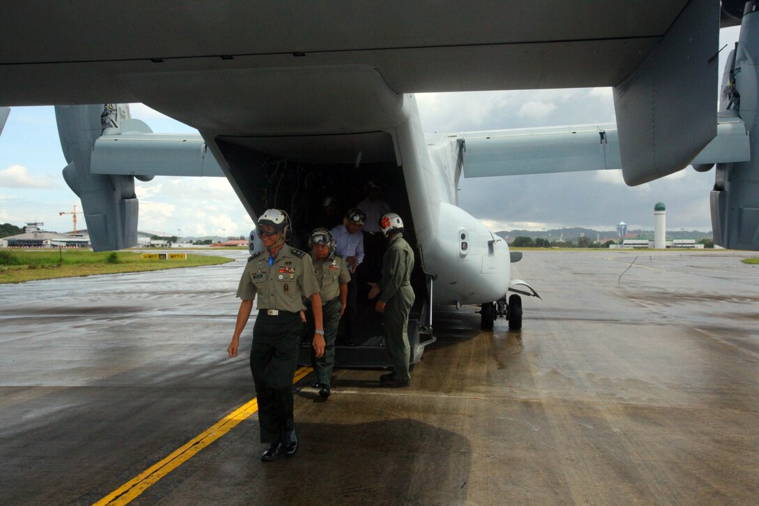 Distinguished guests walk off an MV-22B Osprey after taking a demonstration flight Dec. 4 at Rimba Air Base, Brunei, during the 4th biennial Brunei Darussalam International Defense Exhibition and Conference. Government organizations and various companies at BRIDEX 13 represented approximately 70 countries. The five-day event includes displays and demonstrations of military equipment, with the theme of bridging the capability gap. BRIDEX 13 is an opportunity for communication and cooperation with regional partners and allies, builds strong multilateral relationships and enhances preparedness for disasters and other contingency operations. U.S. participation in BRIDEX 13 demonstrates cooperative engagement with Brunei and continued commitment to regional security and stability in the Asia-Pacific region. The Osprey is assigned to Marine Medium Tiltrotor Squadron 262, Marine Aircraft Group 36, 1st Marine Air Wing, III Marine Expeditionary Force. (U.S. Marine Corps photo by Cpl. Alyssa Gunton/Released)