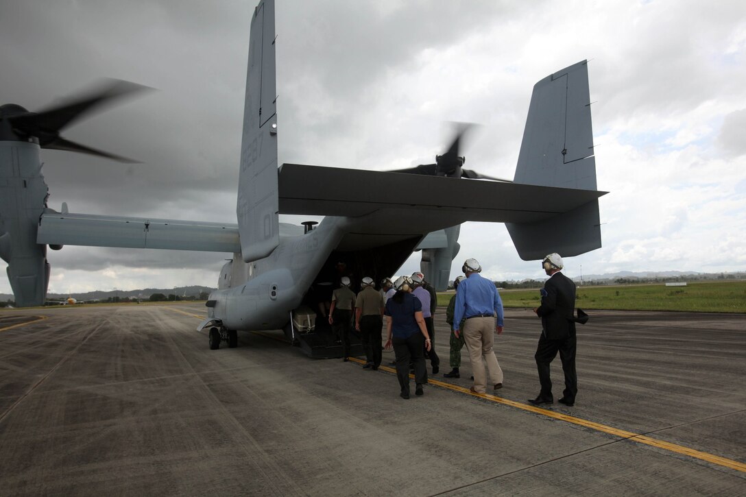 Distinguished guests board an MV-22B Osprey Dec. 4 at Rimba Air Base, Brunei, during the 4th biennial Brunei Darussalam International Defense Exhibition and Conference. Government agencies and various companies at BRIDEX 13 represented approximately 70 countries. The five-day event includes displays and demonstrations of military equipment, with the theme of bridging the capability gap. BRIDEX 13 is an opportunity for communication and cooperation with regional partners and allies, builds strong multilateral relationships and enhances preparedness for disasters and other contingency operations. U.S. participation in BRIDEX 13 demonstrates cooperative engagement with Brunei and continued commitment to regional security and stability in the Asia-Pacific region. The Osprey is assigned to Marine Medium Tiltrotor Squadron 262, Marine Aircraft Group 36, 1st Marine Air Wing, III Marine Expeditionary Force. (U.S. Marine Corps photo by Cpl. Alyssa Gunton/Released)