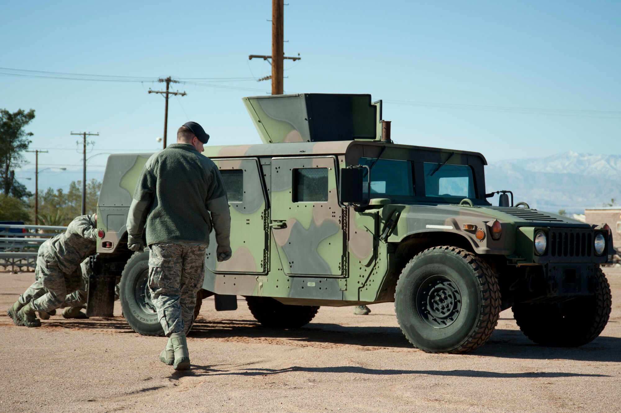 Airmen compete in the HUMVEE push portion of the 99th Security Forces Squadron Warrior Challenge event Dec. 6, 2013, at Nellis Air Force Base, Nev. Teams of four Airmen pushed the HUMVEE 50 feet competing for the fastest time. (U.S. Air Force photo by Airman 1st Class Timothy Young)