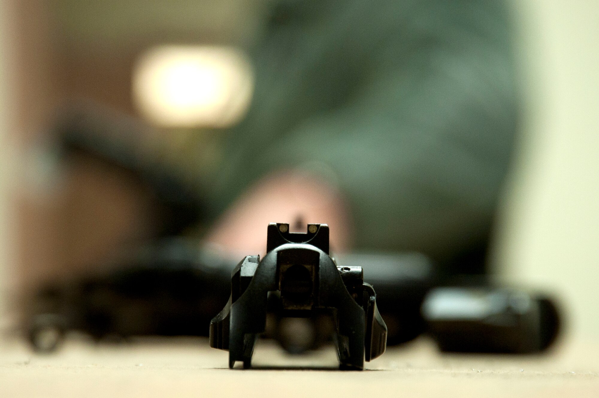 Pieces of a disassembled M-9 pistol sits on a table top prior to a 99th Security Forces Squadron Warrior Challenge event Dec. 6, 2013, at Nellis Air Force Base, Nev. The 99th SFS Challenge challenged Airmen in teamwork and resilience during events including a pushups and sit-ups contest, target competition, ruck march, M-4 rifle and M-9 pistol assembly. During the weapons assembly, Airmen were required to field strip the weapons according to Air Force Instruction 31-117 Arming and use of force by Air Force personnel. (U.S. Air Force photo by Airman 1st Class Timothy Young)