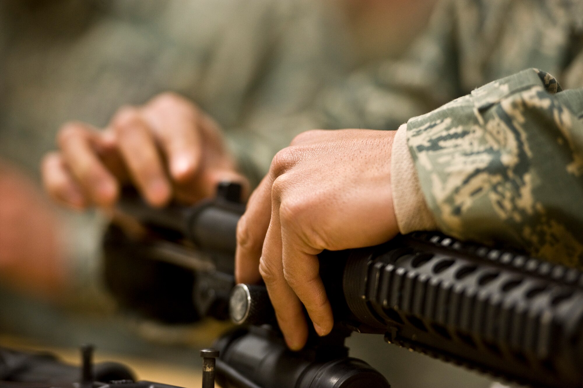 An Airman assembles an M-4 carbine during the 99th Security Forces Squadron Warrior Challenge Dec. 6, 2013, at Nellis Air Force Base, Nev. A total of 17 teams participated in the challenge course hosted by the 99th Security Forces Squadron. (U.S. Air Force photo by Airman 1st Class Christopher Tam)