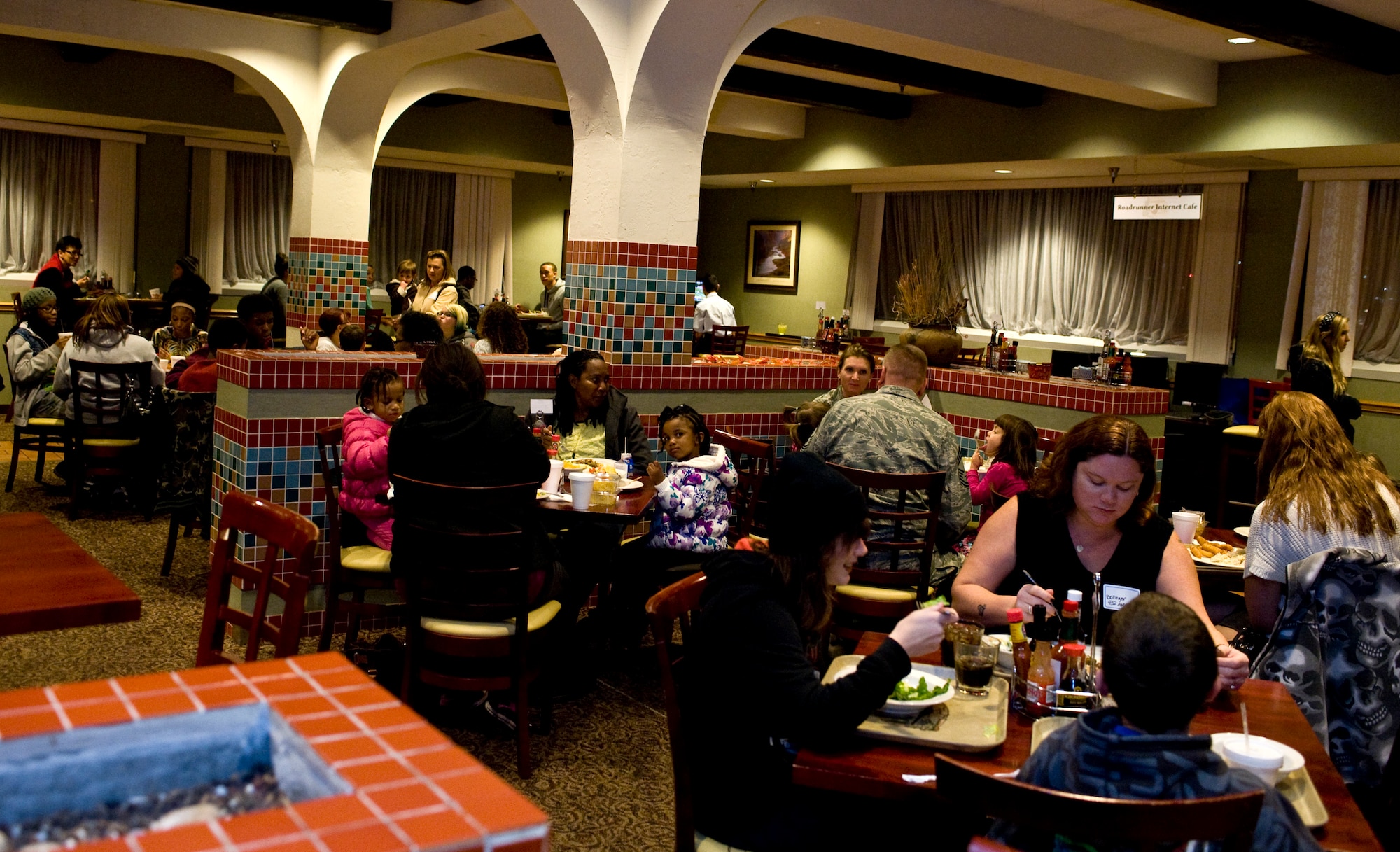 Families of deployed Airmen and service members on remote assignments attend a free dinner at the Crosswinds Dining Facility Dec. 4, 2013, at Nellis Air Force Base, Nev. This dinner happens monthly and is sponsored by the airman and family readiness center. These dinners are hosted monthly. (U.S. Air Force photo by Senior Airman Matthew Lancaster)