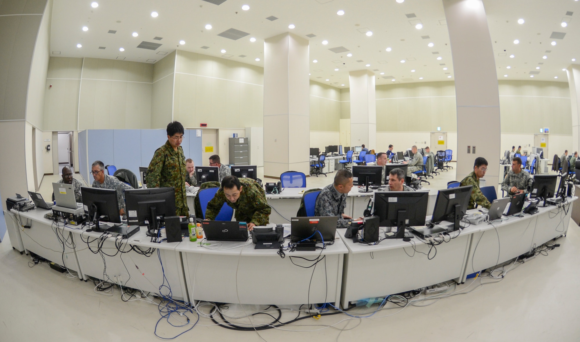 Military members from the U.S. Air Force, U.S. Army, Japan Air Self-Defense Force and Japan Ground Self-Defense Force gather in the Bilateral Air Operations Coordination Center at Yokota Air Base to participate in Yama Sakura 65, Dec. 9, 2013. Yama Sakura, which means “mountain cherry blossom,” is an annual-bilateral exercise training Japanese and U.S. military members to defend the country against a simulated attack. (U.S. Air Force photo by Senior Airman Michael Washburn/Released)