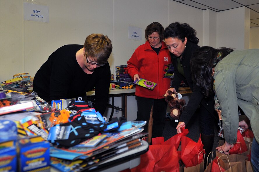 Team Fairchild spouses sort toys for the Operation Homefront Toy Drive Dec. 3, 2013, at Fairchild Air Force Base, Wash. Operation Homefront provides emergency financial and other assistance to the families of our service members and wounded warriors. (U.S. Air Force photo by Staff Sgt. Veronica Montes/Released)