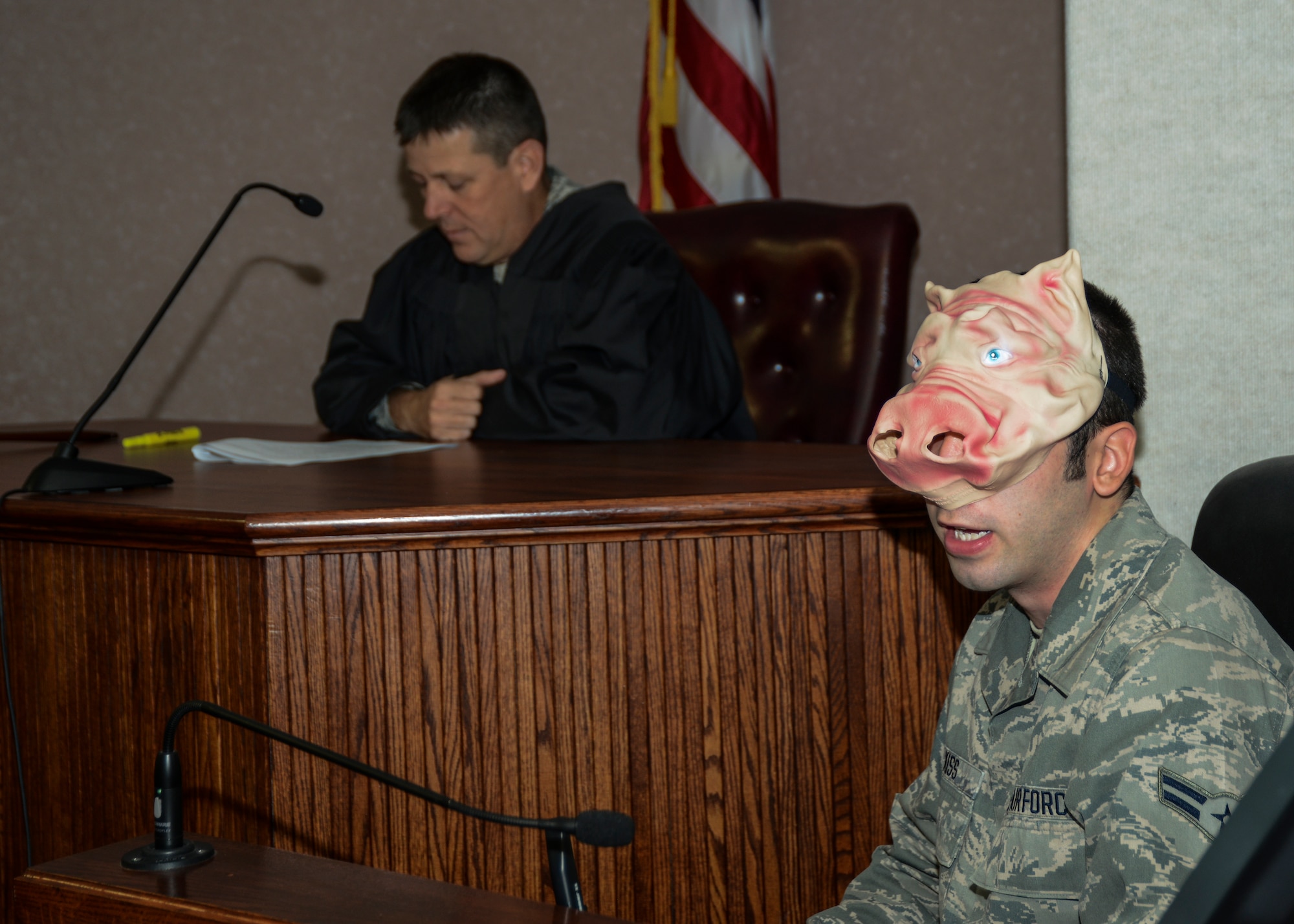 Curly Pig, portrayed by Airman 1st Class William Kiss (right), 412th Test Wing, Judge Advocate Office, takes the stand. The judge, played by Col. Wesley Moore, Air Force Test Center Staff Judge Advocate, listens to Pigs' testimony. (U.S. Air Force photo by Rebecca Amber).