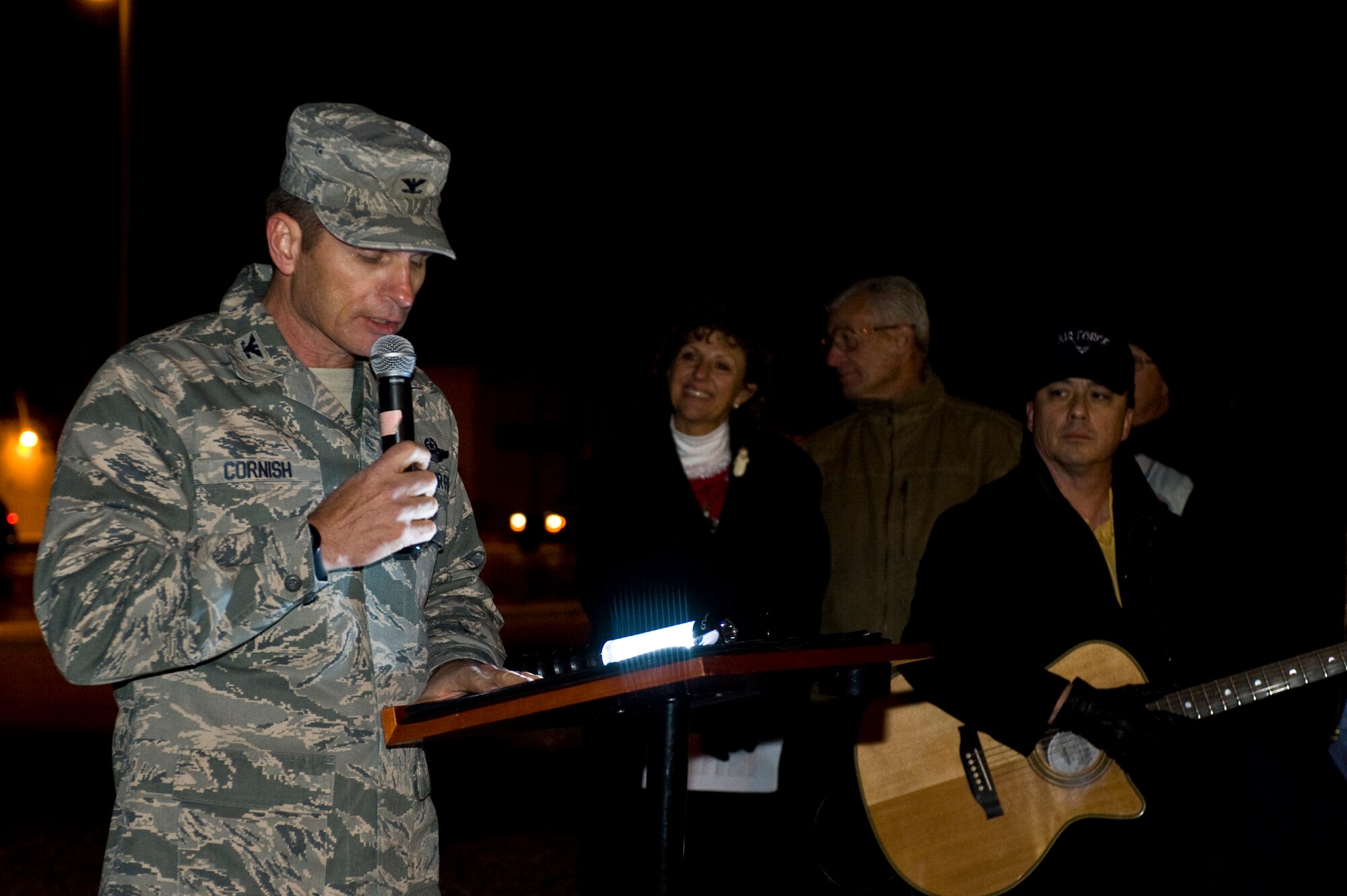 U.S. Air Force Col. Barry Cornish, 99th Air Base Wing commander, speaks to approximately 100 Airmen and families outside the chapel during a menorah and tree lighting ceremony Dec. 6, 2013, at Nellis Air Force Base, Nev. Airmen and their families gathered outside the chapel to celebrate the lighting of the tree and menorah which will be lit for the whole month of December. (U.S. Air Force photo by Airman 1st Class Christopher Tam)