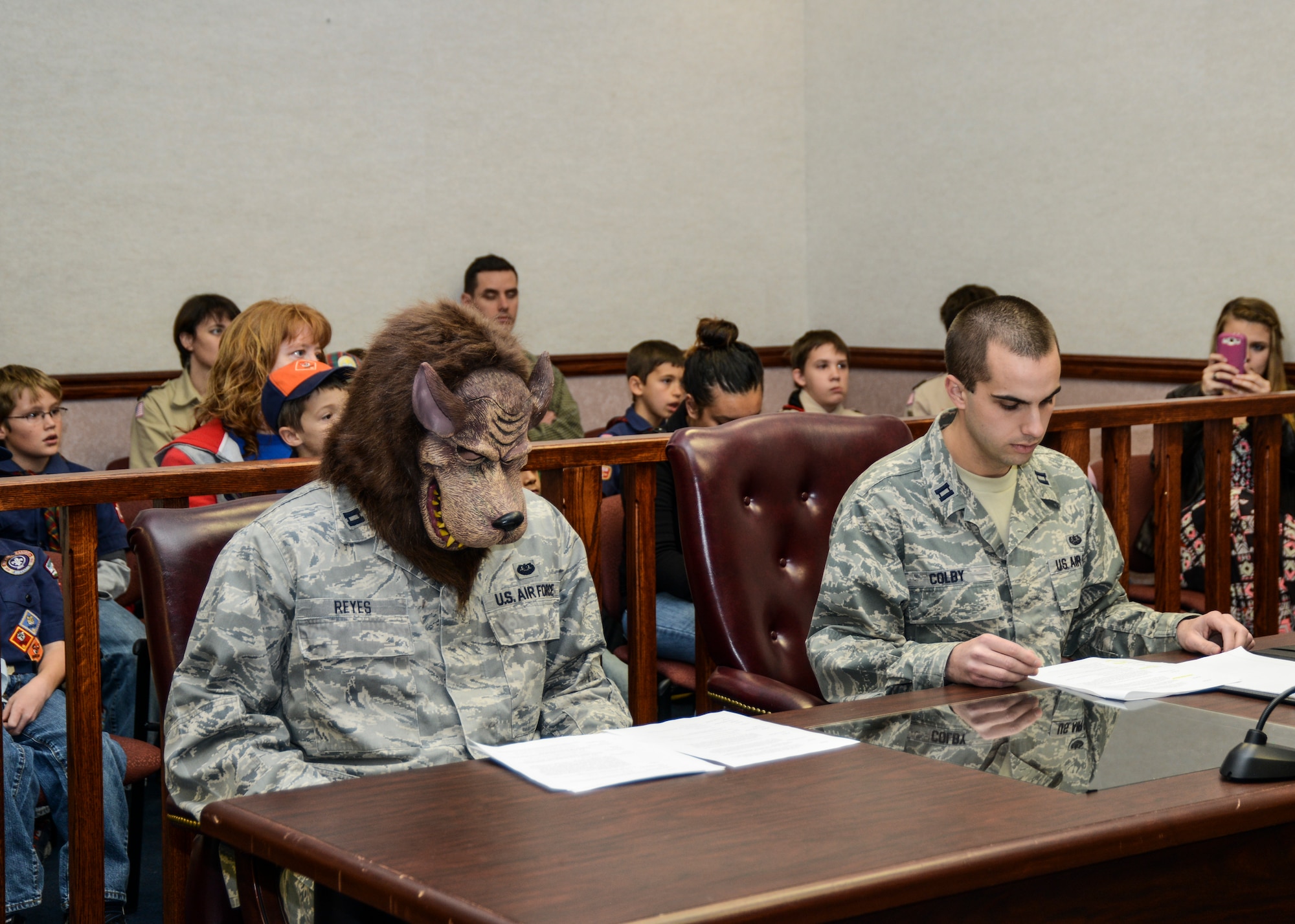 Big Bad Wolf, portrayed by Capt. Nicholas Reyes (left) 412th Test Wing, Judge Advocate, and his attorney Capt. Thomas Colby, 412th TW, JA, listen as Curly Pig is questioned by his attorney during a mock trial held Dec. 9 at the Base Courthouse. The mock trial was to show local Cub Scout Wolf Den Pack 741 a glimpse of how the legal system works. (U.S. Air Force photo by Rebecca Amber).