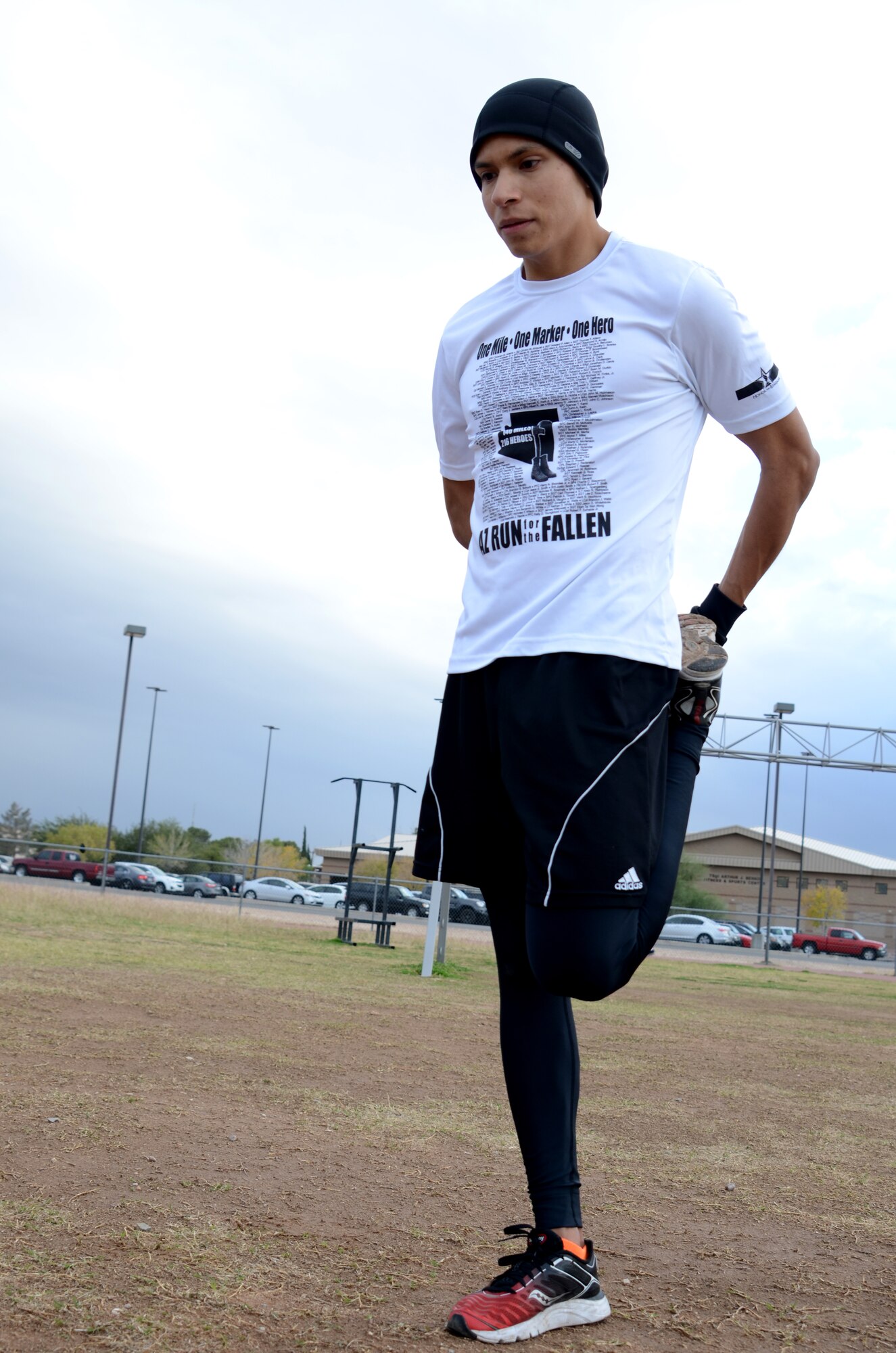 Senior Airman Savas Rivera, a regional weather forecaster/special support forecaster assigned to the 612th Support Squadron, stretches after a run at the base track on Davis-Monthan AFB, Ariz., Dec. 5, 2013.  Stretching helps reduce soreness from running and helps increase flexibility. (U.S. Air Force photo by Staff Sgt. Heather R. Redman/Released)   