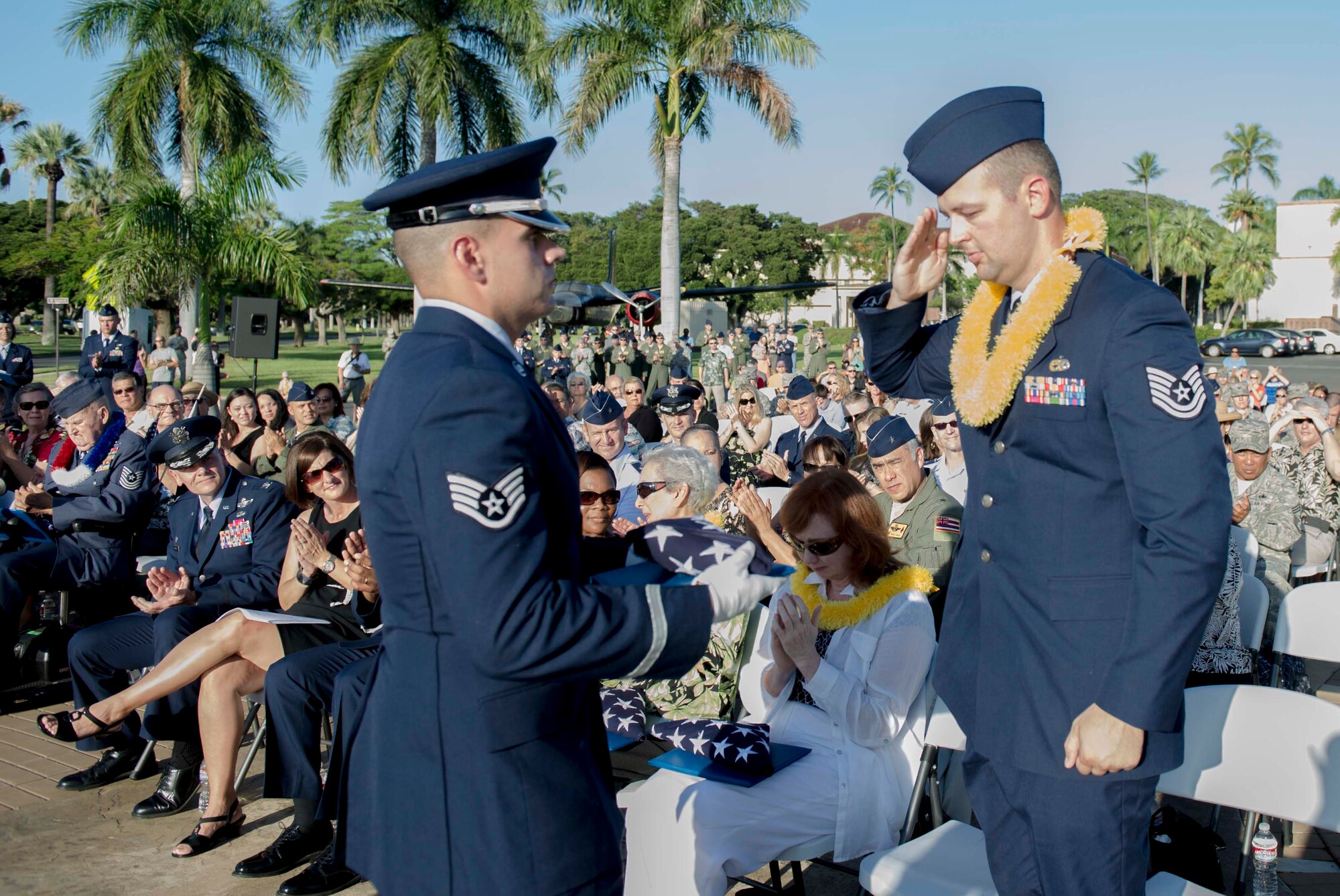 Tech. Sgt. Andrew Shepherd, right, 15th Aircraft Maintenance Squadron, renders a salute before being presented a flag by a Hickam Honor Guard member during the December 7th Remembrance Ceremony at Hickam Field, Dec. 7, 2013. Shepherd is the grandson of Hickam Field Attack survivor, Marion Shepherd, and received the flag in honor and recognition of his grandfather’s selfless service. Shepherd has been assigned to Hickam since August 2013 and served as a volunteer and honored guest at a Dec. 7, 1941, remembrance ceremony which paid homage to the 190 fallen Airmen and civilians, as well as the survivors.  (U.S. Air Force photo/Staff Sgt. Terri Paden)