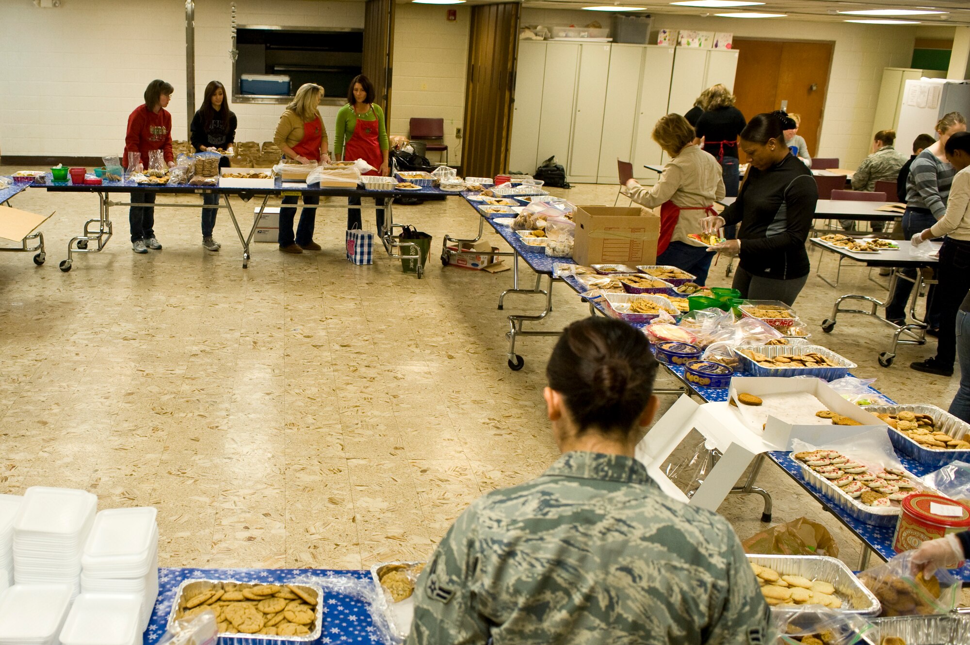 The Senior Leadership Spouses Committee, Airmen and volunteers from the local community sort cookies during the annual Cookie Drive at the chapel Dec. 9, 2013, at Nellis Air Force Base, Nev. The base received 15,000 cookies, 12,000 of which were donated by the local community and were packaged for delivery to Airmen living in the dorms. The remaining cookies were distributed to units around the base. (U.S. Air Force photo by Airman 1st Class Christopher Tam)