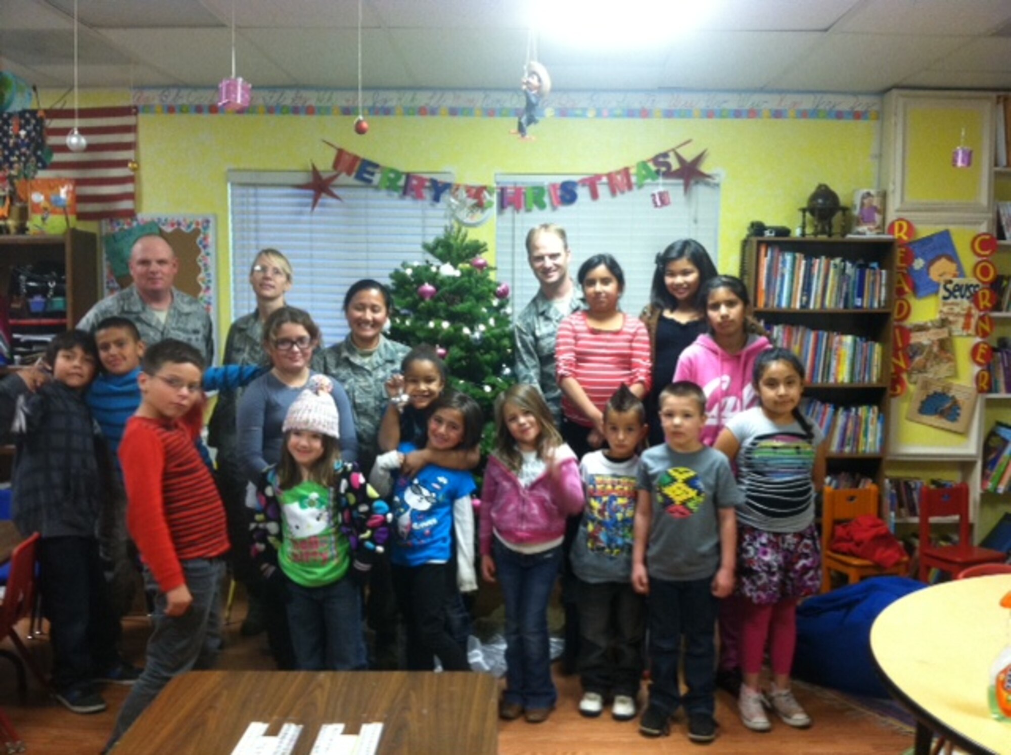 VANDENBERG AIR FORCE BASE, Calif. – Volunteers from 14th Air Force and Joint Functional Component Command for Space pose for a photo with a group of children from the Good Samaritan After School Youth Program in Santa Maria, Calif. Eight teams of approximately 450 Airmen and joint partners from JFCC SPACE and 14 AF participated in an effort to accomplish more than 3,850 hours of volunteer service in the local area during this holiday season. (U.S. Air Force Courtesy Photo)