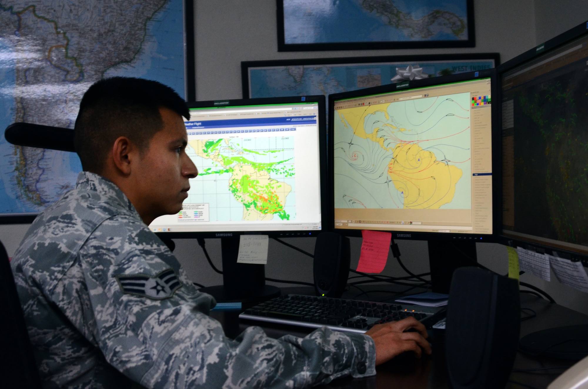Senior Airman Savas Rivera, a regional weather forecaster/special support forecaster assigned to the 612th Support Squadron, uses several programs to analyze the atmosphere and monitor weather patterns on Davis-Monthan AFB, Ariz., Dec. 5, 2013.  Rivera uses the programs to create forecasts for the forward operating locations within the U.S. Southern Command area of responsibility.   (U.S. Air Force photo by Staff Sgt. Heather R. Redman/Released)