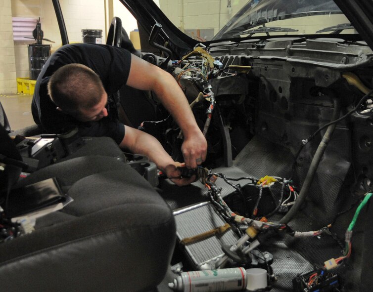 Staff Sgt. Cody Steward, 2nd Logistics Readiness Squadron vehicle maintenance technician, inspects a duct to a heating, ventilation, and air conditioning module in a truck on Barksdale Air Force Base, La., Dec. 10, 2013. Once the discrepancy is found, Steward will correct it to ensure the AC and heat are properly functioning. (U.S. Air Force photo/Senior Airman Kristin High)