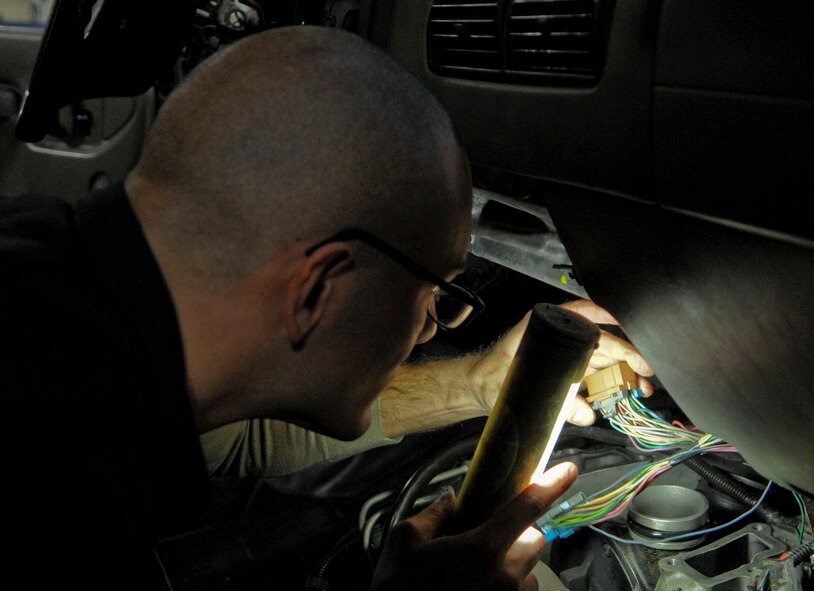 Senior Airman Jon Moore, 2nd Logistics Readiness Squadron vehicle maintenance technician, troubleshoots codes in a multi-stop van on Barksdale Air Force Base, La., Dec. 9, 2013. The multi-stop vehicles are used to transport cargo, personnel and tools to maintenance Airmen on the flightline. (U.S. Air Force photo/Senior Airman Kristin High)