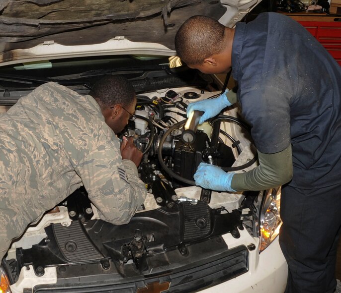 Staff Sgt. Jonathan Graham (left) and Senior Airman Kevin Richberg-Brown, 2nd Logistics Readiness Squadron vehicle maintenance technicians, inspect an anti-lock brake system on Barksdale Air Force Base, La., Dec. 9, 2013. The inspection was conducted during a preventative maintenance check to ensure proper function. (U.S. Air Force photo/Senior Airman Kristin High)