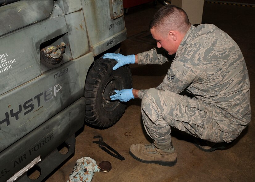 Airman 1st Class Cody Akers, 2nd Logistics Readiness Squadron vehicle maintenance technician, tightens a castle nut on the wheel of a fork lift on Barksdale Air Force Base, La., Dec. 9, 2013. The vehicle maintenance section maintains a wide range of vehicles to include fire trucks, refueling trucks, every day-use vehicles, ambulances, buses and maintenance trucks used to tow aerospace ground equipment. (U.S. Air Force photo/Senior Airman Kristin High)