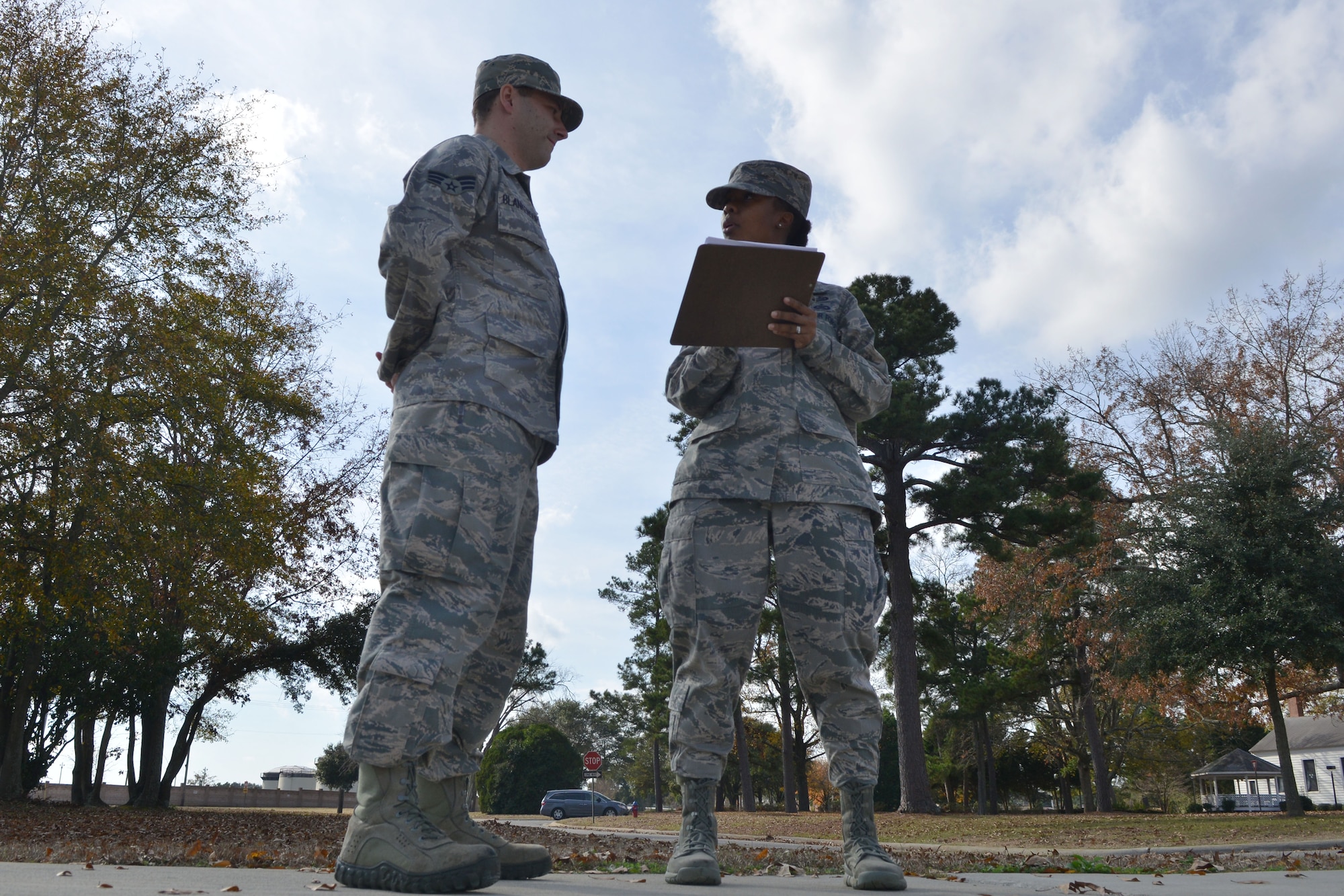 U.S. Air Force Tech. Sgt. Thyiatira Singleton, 20th Force Support Squadron airman leadership school instructor, explains to one of her students how he did during their last drill for the class, Shaw Air Force Base, S.C., Dec.6, 2013.The Airmen are graded on their marching abilities and also the abilities to march a flight. (U.S. Air Force photo by Senior Airman Ashley L. Gardner/ Released)