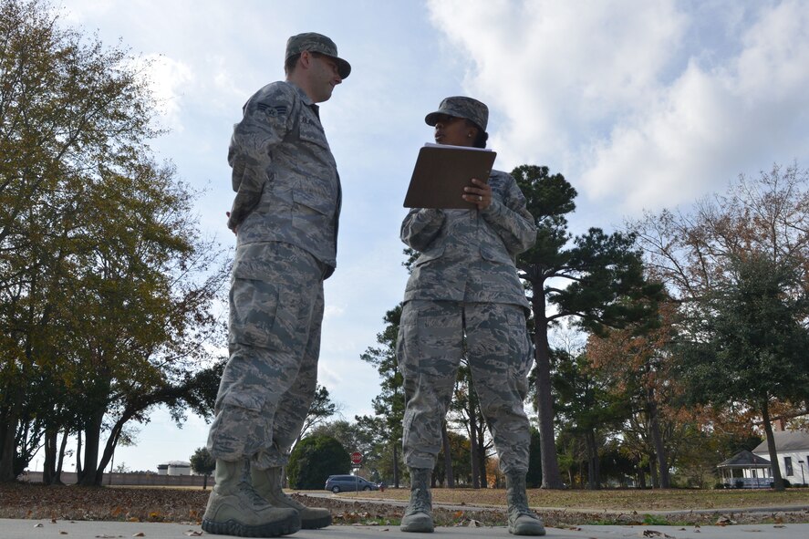 U.S. Air Force Tech. Sgt. Thyiatira Singleton, 20th Force Support Squadron airman leadership school instructor, explains to one of her students how he did during their last drill for the class, Shaw Air Force Base, S.C., Dec.6, 2013.The Airmen are graded on their marching abilities and also the abilities to march a flight. (U.S. Air Force photo by Senior Airman Ashley L. Gardner/ Released)