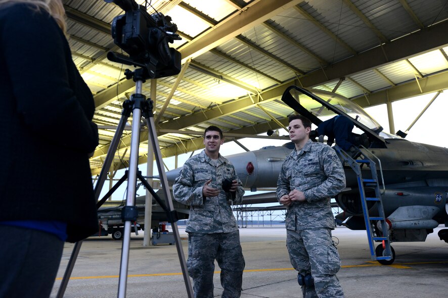 Staff Sgt. Benjamin Mockovciak and Senior Airman Matthew Katz, 20th Aircraft Maintenance Squadron, Shooter Aircraft Maintenance Unit tactical aircraft maintainers, explain job specifics to Rebecca Bazzle, Microburst Learning creative director Dec. 3, 2013, Shaw Air Force Base, S.C. The Airmen’s interviews will be used to create military and job-specific e-learning modules to provide South Carolina high school students career opportunity information. (U.S. Air Force photo by Senior Airman Laura L. Valentine/Released)