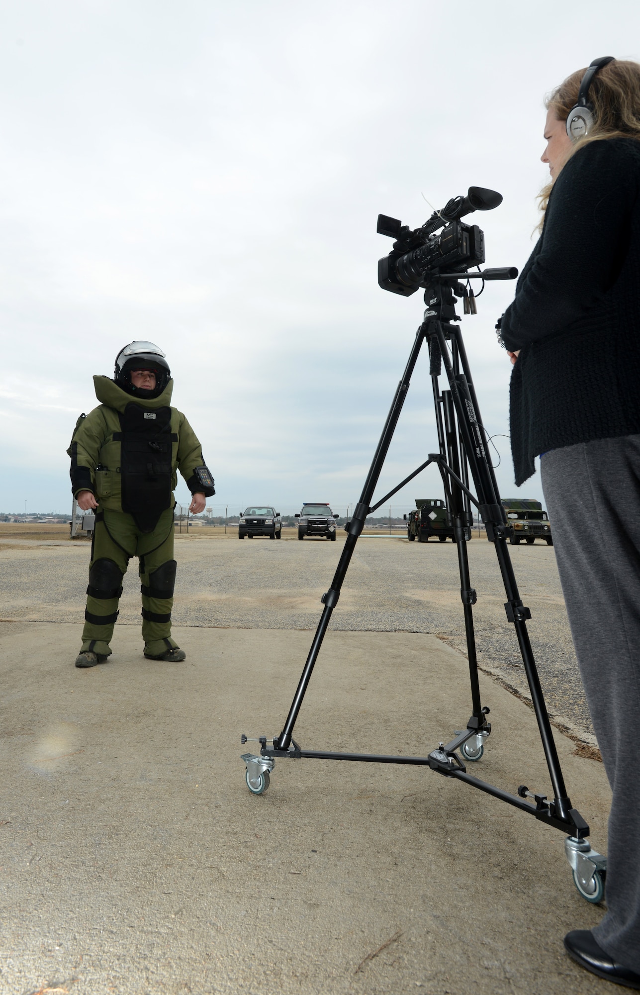 Airman 1st Class Adrian McCoy, 20th Civil Engineer Squadron Explosive Ordnance Disposal apprentice, answers questions about being an EOD Airman from Rebecca Bazzle, Microburst Learning creative director Dec. 3, 2013, Shaw Air Force Base, S.C. McCoy donned the EOD 9 bomb suit for the interview which will be used as part of e-learning modules produced by Microburst to provide South Carolina high school students career opportunity information. (U.S. Air Force photo by Senior Airman Laura L. Valentine/Released)