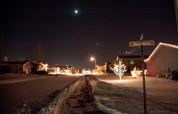 Holiday lights fade into the distance at the corner of Delta Dr. at Minot Air Force Base, N.D., Dec. 7. Base housing rules dictate that exterior decorations may be lit between the hours of 6 p.m. - 11 p.m. the week after Thanksgiving through New Year’s Day. (U.S. Air Force photo/Senior Airman Stephanie Sauberan)