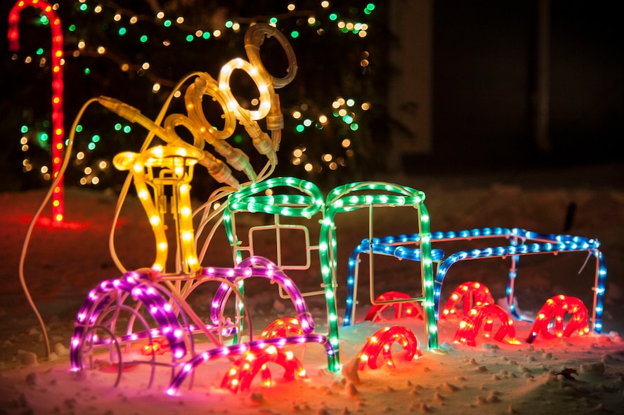 A colorful choo-choo-train blinks in festive colors on the corner of Delta Dr. at Minot Air Force Base, N.D., Dec. 7. Base housing rules dictate that residents are not to use indoor extension cords for outdoor decorations. (U.S. Air Force photo/Senior Airman Stephanie Sauberan)