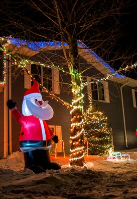 An inflatable waving Santa Claus is visible to motorists on the corner of Delta Dr. at Minot Air Force Base, N.D., Dec. 7. Base housing rules dictate that seasonal decorations must be removed no later than the third week of January. (U.S. Air Force photo/Senior Airman Stephanie Sauberan)
