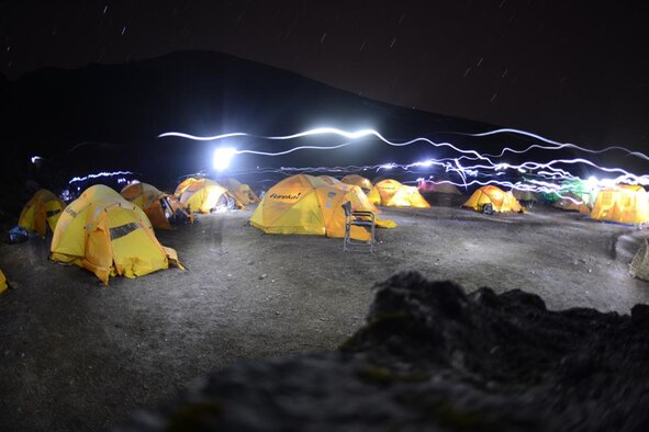 Campers’ headlamps appear as streaks of light at night in Lobuche Basecamp April 18, 2013.  Many Mt. Everest groups now use Lobuche, a 20,000 foot peak, to acclimate, saving a dangerous trip through the crapshoot Khumbu Icefall.  This technique provides less exposure for the climbers and an opportunity to add another peak to their list of climbs. (photo by Nick Gibson)   