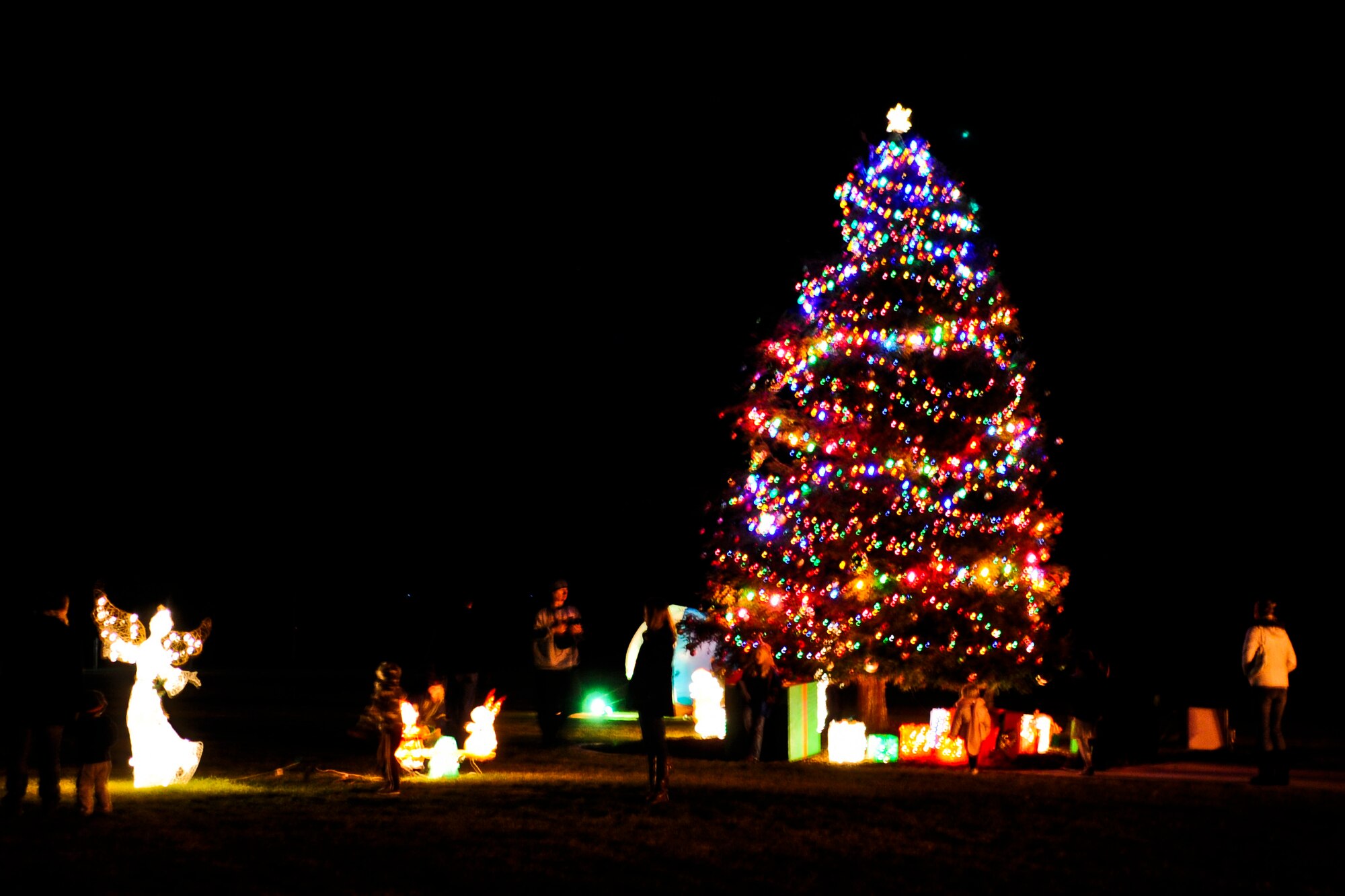 VANDENBERG AIR FORCE BASE, Calif. – Vandenberg’s holiday tree is lit during the annual Tree Lighting Ceremony in front of building 11777 here Dec. 9, 2013. The event included caroling, hot chocolate, the lighting of the tree and a visit from Santa Claus.  (U.S. Air Force photo/ Airman 1st Class Yvonne Morales)