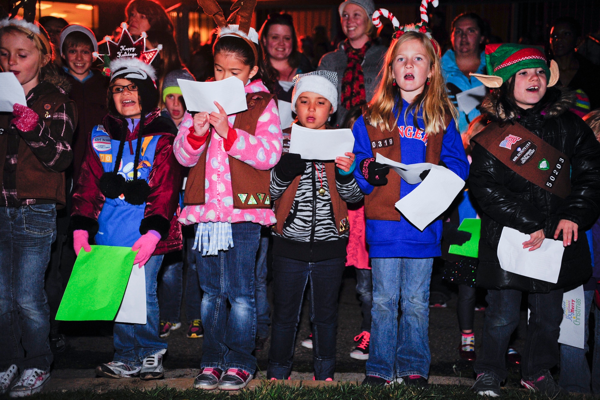 VANDENBERG AIR FORCE BASE, Calif. – Children sing carols during Vandenberg’s annual Tree Lighting Ceremony in front of building 11777 here Dec. 9, 2013. The base ushered in the holiday season with the lighting of the tree, hot chocolate, and a surprise visit from Santa Clause. (U.S. Air Force photo/ Airman 1st Class Yvonne Morales)