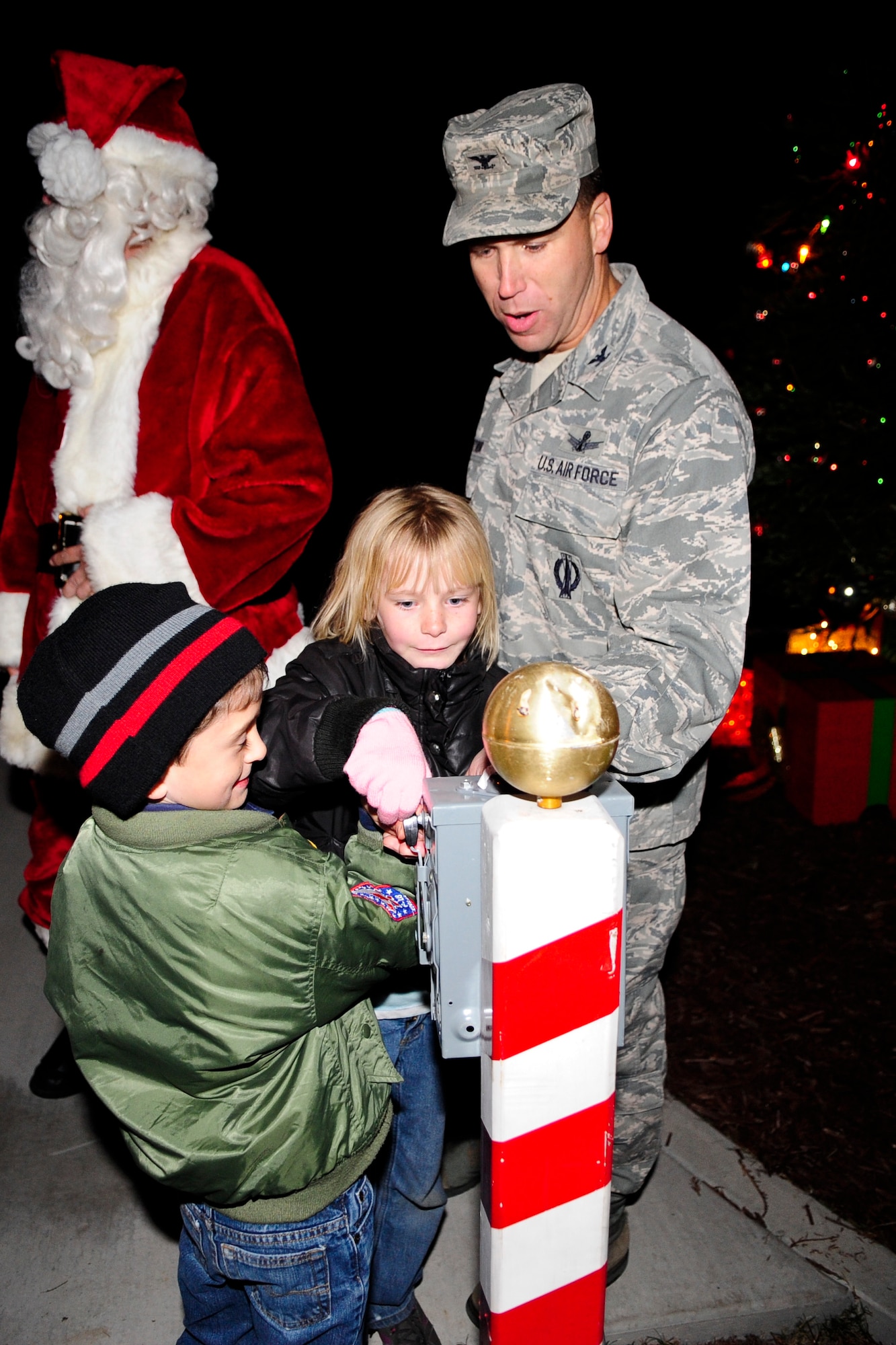 VANDENBERG AIR FORCE BASE, Calif. – Col. Brent McArthur, 30th Space Wing vice commander, and two children from the Vandenberg Girl and Boy Scouts prepare to light the tree during Vandenberg’s annual Tree Lighting Ceremony here Dec. 9, 2013. The event included caroling, hot chocolate, the lighting of the tree and a visit from Santa Claus.  (U.S. Air Force photo/ Airman 1st Class Yvonne Morales)