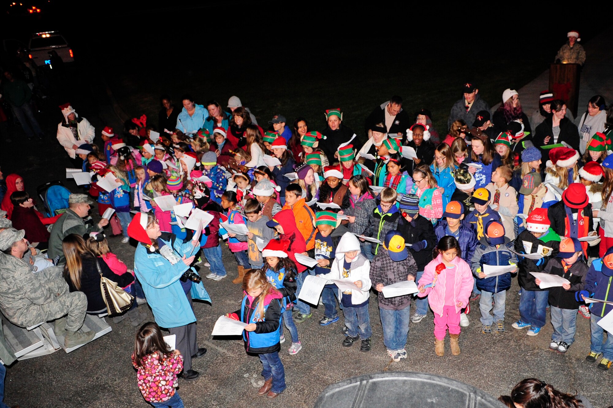 VANDENBERG AIR FORCE BASE, Calif. – Vandenberg Girl and Boy Scouts sing carols for Team V during Vandenberg’s annual Tree Lighting Ceremony in front of building 11777 here Dec. 9, 2013. The event included caroling, hot chocolate, the lighting of the tree and a visit from Santa Claus.  (U.S. Air Force photo/ Airman 1st Class Yvonne Morales)