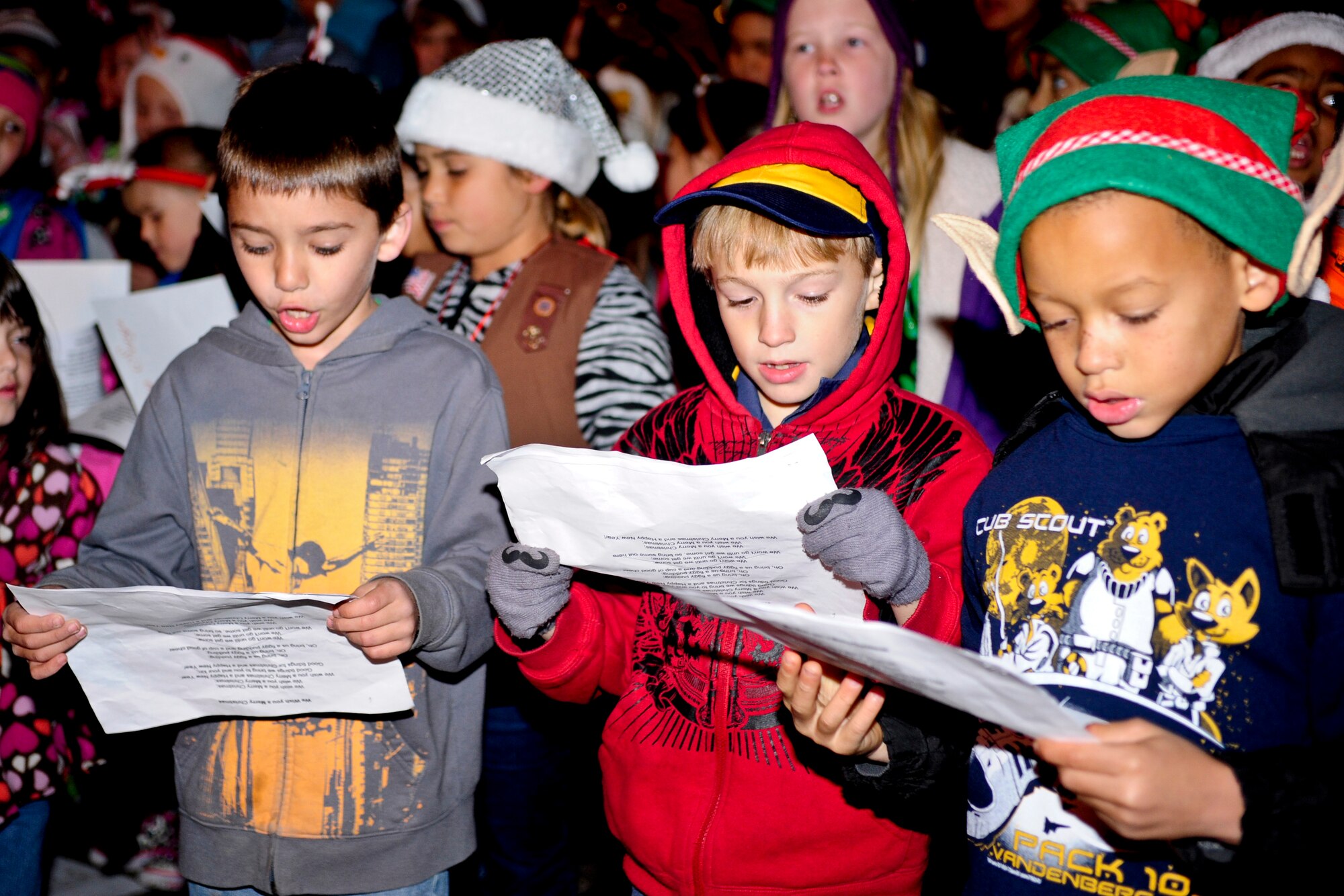 VANDENBERG AIR FORCE BASE, Calif. – Vandenberg Girl and Boy Scouts sing carols for Team V during Vandenberg’s annual Tree Lighting Ceremony in front of building 11777 here Dec. 9, 2013. The event included caroling, hot chocolate, the lighting of the tree and a visit from Santa Claus.  (U.S. Air Force photo/ Airman 1st Class Yvonne Morales)