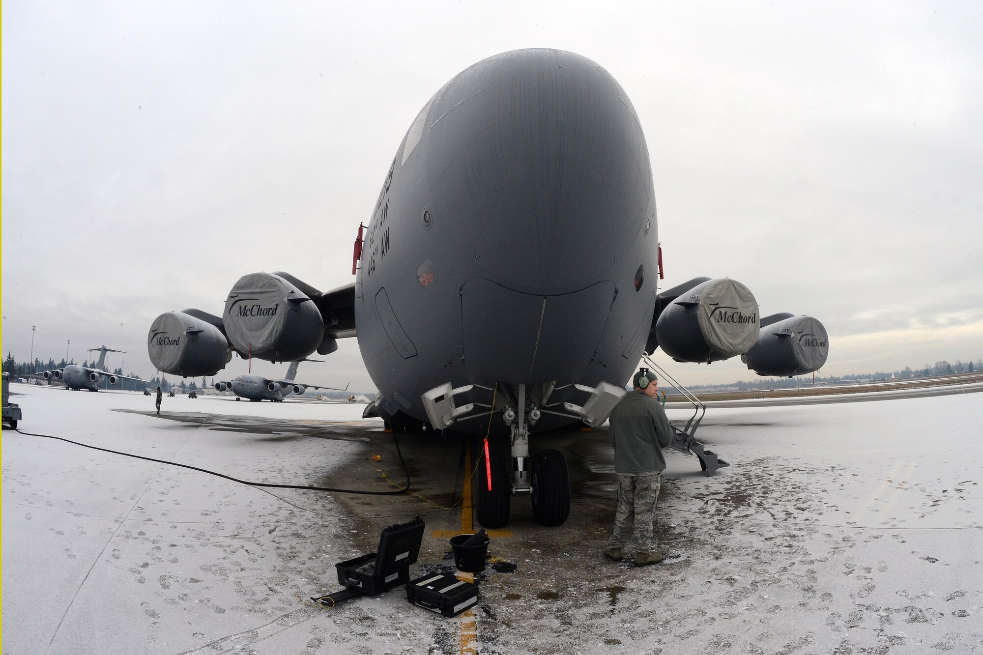 A maintainer from the 62nd Aircraft Maintenance Squadron prepares for inspection of C-17 Globemaster III aircraft, Dec. 10, 2013 at Joint Base Lewis-McChord, Wash. Maintainers began the morning de-icing aircraft tasked for missions. (U.S. Air Force photo/Airman 1st Class Jacob Jimenez)