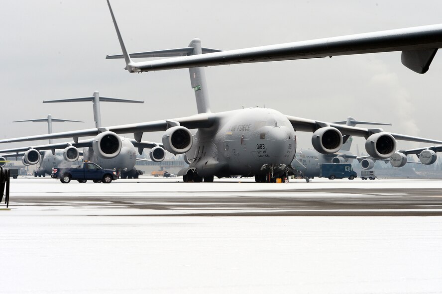 A C-17 Globemaster III aircraft is parked on the McChord Field ramp, Dec. 10, 2013 at Joint Base Lewis-McChord, Wash. Earlier in the morning, McChord Field experienced its first snow fall of the season. (U.S. Air Force photo/Airman 1st Class Jacob Jimenez) 