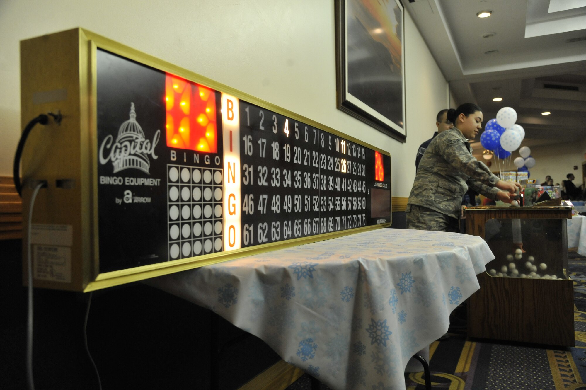 U.S. Air Force Airman 1st Class Cynthia Davis, 509th Force Support Squadron apprentice, hosts the bingo contest at Whiteman Air Force Base, Mo., Dec. 3, 2013. The bingo contest was held at the Mission’s End as part of the festivities after the base tree-lighting ceremony. (U.S. Air Force photo by Airman 1st Class Keenan Berry/Released)