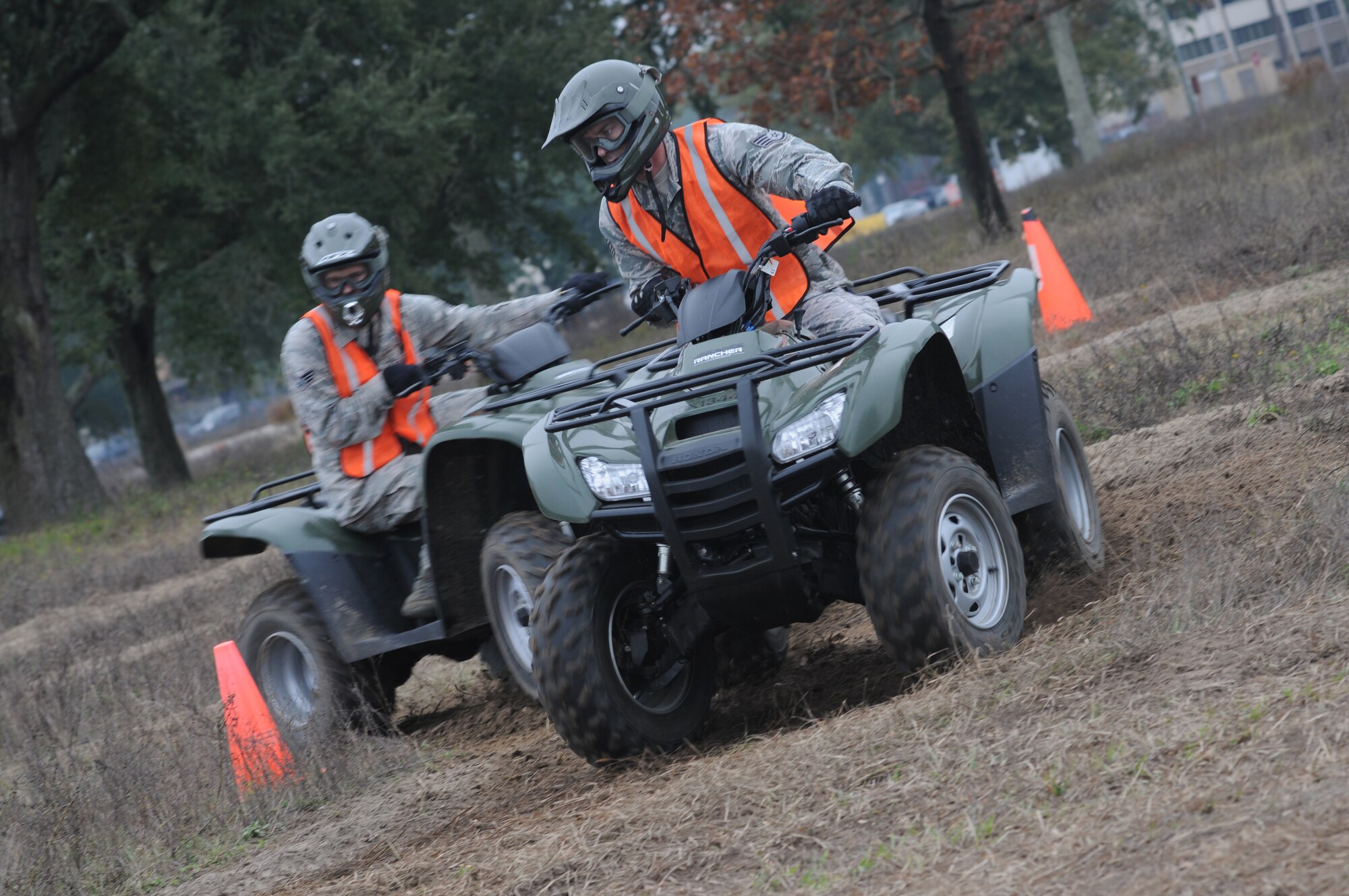 Senior Airman Stephen Nores and Staff Sgt. Brandon Harris, 81st Security Forces Squadron, rides through an obstacle course during a basic All Terrain Vehicle Rider Course Dec. 6, 2013, at Keesler Air Force Base, Miss.  The course, presented by the ATV Safety Institute and instructed by Master Sgt. Jeffrey Moody, 81st Wing Staff Agency first sergeant, is designed to give riders the skills necessary to safely operate the vehicles and to react in an emergency situation.  The course began with a safety briefing and a physical inspection on the ATVs.  (U.S. Air Force photo by Kemberly Groue)