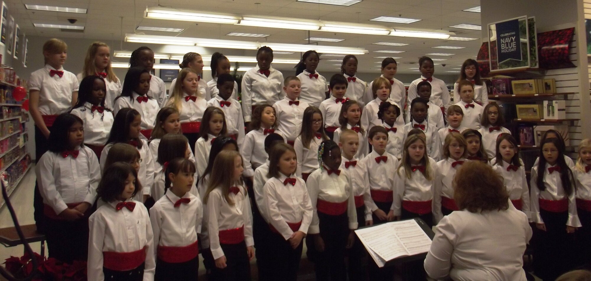 The so and so Children's choir greets customers Dec. 7, 2013, at the Navy Exchange on Joint Base Charleston - Weapons Station. The Navy Exchange opened early for children to get some special time with Santa and his elves and to be able to pick out just the right presents for their mom and dad. (Courtesy Photo/April Ware)

