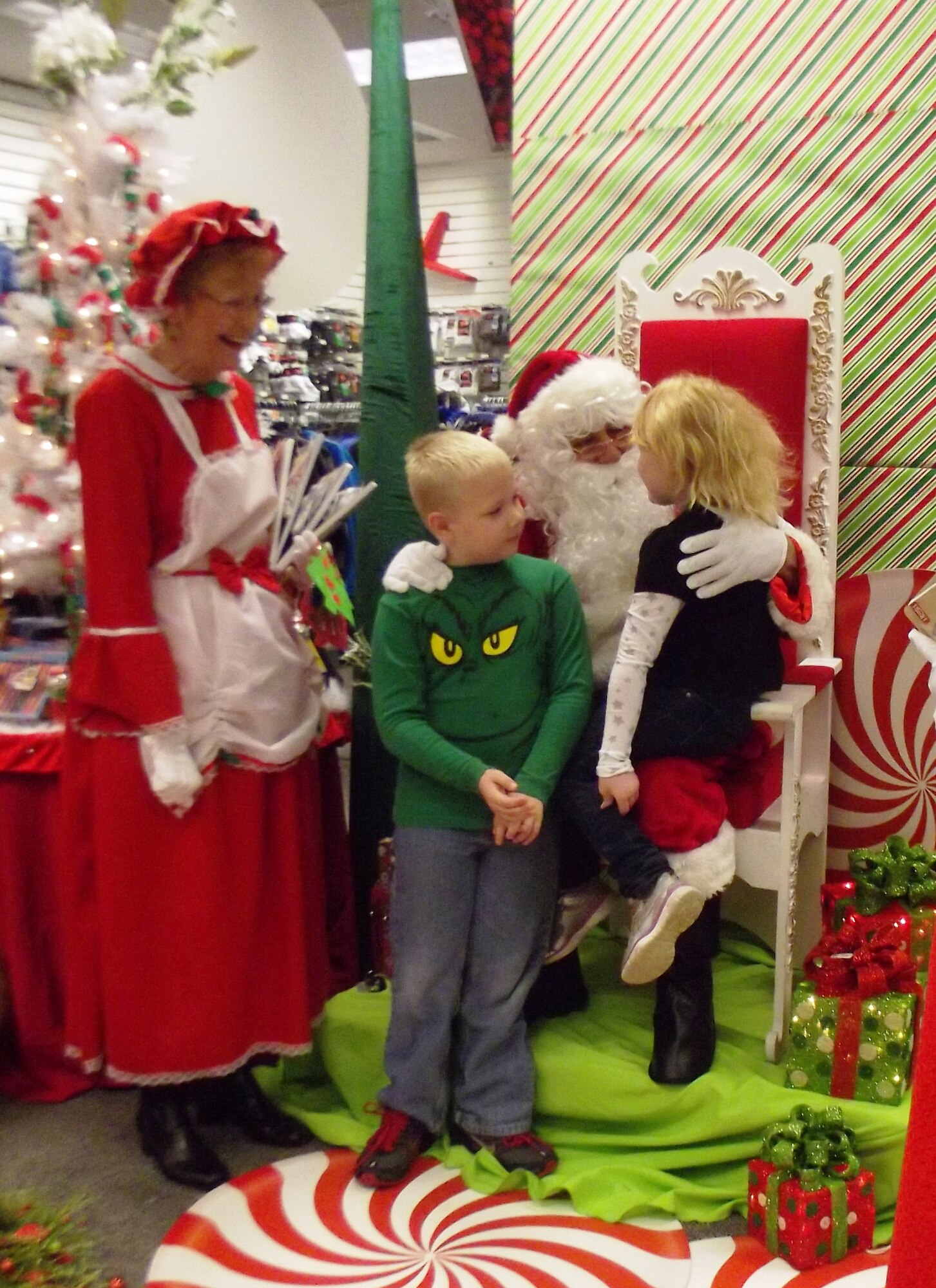 Santa and Mrs. Claus greet children during the Navy Exchange Children's shopping day Dec. 7, 2013 at the Navy Exchange on Joint Base Charleston - Weapons Station. The Navy Exchange opened early for children to get some special time with Santa and his elves and to be able to pick out just the right presents for their mom and dad. (Courtesy Photo/April Ware)