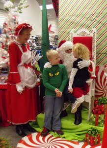 Santa and Mrs. Claus greet children during the Navy Exchange Children's shopping day Dec. 7, 2013 at the Navy Exchange on Joint Base Charleston - Weapons Station. The Navy Exchange opened early for children to get some special time with Santa and his elves and to be able to pick out just the right presents for their mom and dad. (Courtesy Photo/April Ware)