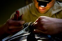 Senior Airman Sean Donnelly, 5th Maintenance Squadron aerospace propulsion technician assembles the aft mount of a B-52H Stratofortress engine at Minot Air Force Base, N.D., Dec. 4, 2013. Keeping engines fully capable to carry out any task a pilot may have is what the propulsion flight does every day. The Airmen who work on these engines are fully trained and qualified to handle a multitude of procedures. (U.S. Air Force photo/Senior Airman Brittany Y. Auld)