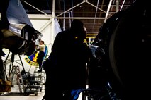 Staff Sgt. Adrian Brown assists Senior Airman Sean Donnelly, 5th Maintenance Squadron aerospace propulsion technicians in assembling B-52H Stratofortress engine aft mount at Minot Air Force Base, N.D., Dec. 4, 2013. Aerospace Propulsion specialists from the 5th MXS ensure B-52 engines are in first-rate operational condition. (U.S. Air Force photo/Senior Airman Brittany Y. Auld)