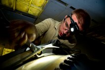 Senior Airman Sean Donnelly, 5th Maintenance Squadron aerospace propulsion technician tightens a bolt while assembling a B-52H Stratofortress engine aft mount at Minot Air Force Base, N.D., Dec. 4, 2013. Aerospace Propulsion specialists from the 5th MXS ensure B-52 engines are in first-rate operational condition. (U.S. Air Force photo/Senior Airman Brittany Y. Auld)
