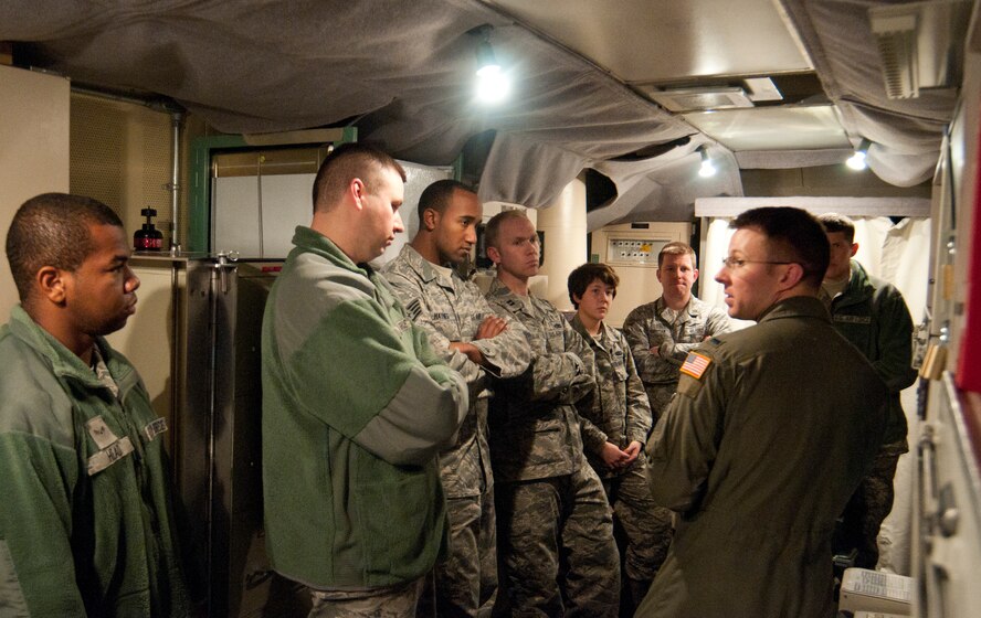 First Lt. Cory Elder, 321st Missile Squadron missile combat crew commander, explains different instruments on a control panel Dec. 9, 2013, in the Kilo-01 Missile Alert Facility Launch Control Center and discusses what a missileer’s duties entail. (U.S. Air Force photo by Airman 1st Class Jason Wiese)
