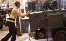 Airman 1st Class Michael Davis, 5th Aircraft Maintenance Squadron team member, pushes a ground heater outside at Minot Air Force Base, N.D., Dec. 5, 2013. Members of the aerospace ground equipment flight endure the cold weather to perform maintenance on the equipment used for aircraft maintenance. (U.S. Air Force photo/Airman 1st Class Apryl Hall)