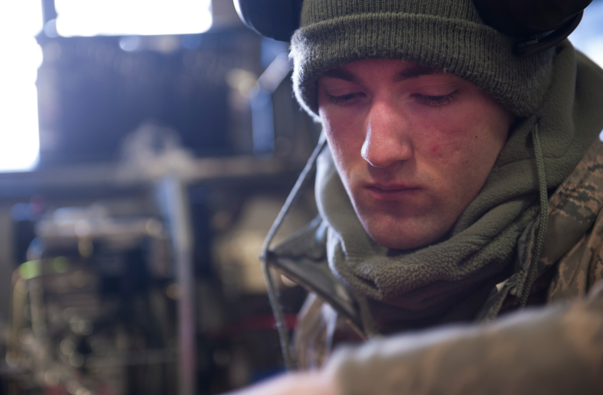 Airman 1st Class Matthew Carnes, 5th Maintenance Squadron aerospace ground equipment mechanic, checks the hydraulic fluid on a lift used to perform aircraft maintenance at Minot Air Force Base, N.D., Dec. 5, 2013. AGE Airmen are responsible for the maintenance of the equipment that supplies electricity, hydraulic pressure and air pressure as planes receive maintenance on the flight line. (U.S. Air Force photo/Airman 1st Class Apryl Hall)