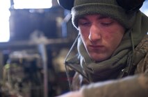 Airman 1st Class Matthew Carnes, 5th Maintenance Squadron aerospace ground equipment mechanic, checks the hydraulic fluid on a lift used to perform aircraft maintenance at Minot Air Force Base, N.D., Dec. 5, 2013. AGE Airmen are responsible for the maintenance of the equipment that supplies electricity, hydraulic pressure and air pressure as planes receive maintenance on the flight line. (U.S. Air Force photo/Airman 1st Class Apryl Hall)