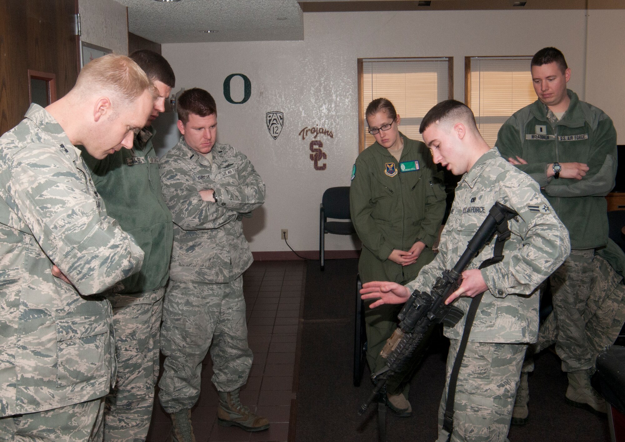 Airman 1st Class Robert Allore, 90th Missile Security Forces Squadron, describes the functions of an M68 Close Combat Optic used on an M4 carbine, which security forces are armed with while patrolling F.E. Warren Air Force Base’s missile complex, Dec. 9, 2013, in the Kilo-01 Missile Alert Facility. (U.S. Air Force photo by Airman 1st Class Jason Wiese)